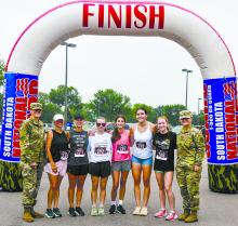 SSG Jessica Anderson (left) and SPC Hannah Huyser (right) join the top five female runners from left to right: Angie Hanson, Laura Robinson, Ashley Stark, Gracelyn Campbell, Calie Davis, and Maylee Rose.