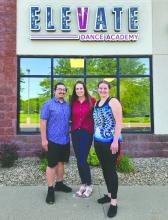 Amphone Nathanvong, Ashley Olsen, and Ruth Marth stand in front of the new Elevate Dance Academy in Dakota Dunes.