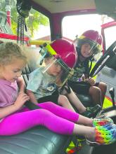 Kids got to check out the interior of a fire truck at National Night Out in Jefferson on Tuesday, Aug 6. L-R: Aubrey Chicoine, Lane Mitchell, Carter Rarrat. Submitted photo