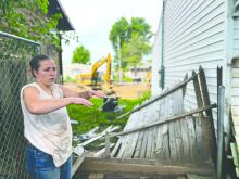 Morgan Speichinger works to clean up her home near McCook Lake on July 3, 2024, after a June 23 flood. Joshua Haiar/South Dakota Searchlight