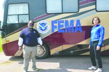 Tony Mayne and Claudia Anderson stand in front of the FEMA mobile unit outside the Disaster Relief Center in North Sioux City. Photo by Kelly Riibe • times2reporter@gmail.com