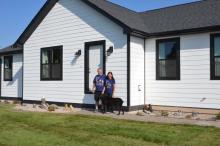 Dave and Judy Oberg stand in front of their new home on the family farm. Photo by Kelly Riibe • times2reporter@gmail.com