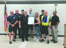 In this picture, members of the NSC Fire Department/EMS pose with Erica Holden. She stopped by to give them a big thank you for their emergency response efforts during her sudden cardiac arrest back in May of 2024. From left: Adam Spates, Jim Christensen, Evan Carlson, Bill Pappas, Tim Bell, Erica Holden, Viktor Sundleaf, Faustin Mahlke, and Rich Headid. Submitted photo