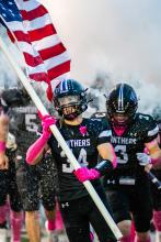 Bennett Lukken and Brady Weaver charge out to the football field on Friday, October 11, 2024.
