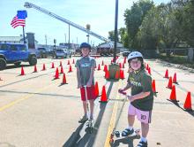 Bentley Watterson and Gracen Beatty, of North Sioux City, had fun riding their scooters through a course of orange safety cones at NSC’s Annual Open House on Oct. 13, 2024. Photo by Kelly Riibe • times2reporter@gmail.com
