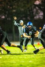 Keaton Gale holds onto the ball on a quarterback keeper play in the 1st round of playoffs for EPJ football. Photos by Peterman Sports Photography • stevepeterman5@gmail.com