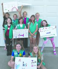 Elk Point-Jefferson Troop 161 holding bedding drive signs. Submitted photo