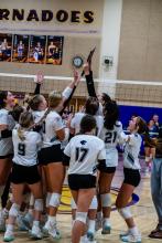 DV volleyball squad celebrates qualifying for the state tournament after beating Hanson in the SODAK 16 Qualifier.
