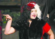 Karlee Hughes, in center dressed as Cruella de Vil, is seen here surrounded by family who loved watching her perform on stage. Submitted photo
