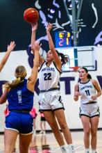 Freshman Aubree Worden takes a shot versus SFC. Her teammate Cameryn Sommervold watches from behind her.
