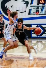 Panther senior Luke Bruns drives hard to the hoop versus the Huskies.