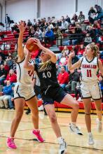 Panther freshman Ella Otten fights through contact for a basket during the DV away game in Vermillion .