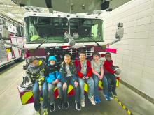 Scouts from Pack 28 learned about fire safety and things they can help their parents look for in their homes. After the scouts toured the fire dept, they learned about some of the gear and equipment firefighters use. Pictured: Gavin Carlson, Graham Carlson, Carter Hunt, Kendy Pierre, Blake Winters, and Tucker Winters. Photo submitted