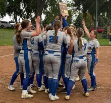 The Huskies celebrate and hold up their state qualifying plaque for softball after winning the SoDAK 16 qualifier game. The state tournament will be in Aberdeen with EPJ taking on West Central on Thursday, June 5, 2025.  			       Submitted photo