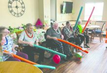 Residents at WEL-Life in Elk Point get into the island spirit during Monday’s Luau Day, enjoying tropical-themed games like “Tiki Toss” and “Pineapple Punch” as part of Assisted Living Week festivities.  Submitted photo