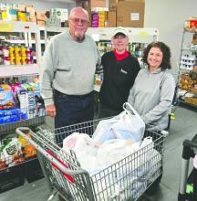 From left, Doug and Cathy Maurstad present donated supplies to Elk Point Food Pantry Manager Tam Edgar. The items were purchased with a $250 Thrivent grant secured by St. Paul Lutheran member Dorothy Langle. Submitted photo
