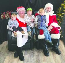 Santa and Mrs. Claus share smiles with children at Elk Point’s Hometown Christmas Market, a highlight of the downtown holiday celebration. Submitted photo