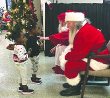 Children visit with Santa and Mrs. Claus during the ARK United Methodist Church’s Kids Free Shopping Spree in North Sioux City, S.D., on Dec. 6, 2025. The annual event pairs children with personal shoppers to select and wrap gifts for family members at no cost. Submitted photo