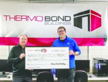 Bill Riley, president and CEO of Thermo Bond Buildings, LLC, presents a $40,000 donation to Elk Point‑Jefferson Superintendent Philip Schonebaum on Nov. 25, 2025, in Elk Point. The contribution will support technology and career education programs for EPJ students. Photo by Peterman Sports Photography • stevepeterman5@gmail.com