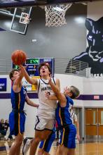 Luke Anema battles through two C-Hawks to get to the basket on December 19, 2025.