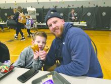 Panther 1st grader Shaw Mitchell ate donuts with his dad, Dallas Mitchell, at Dakota Valley on March 3, 2026. Photo by Kelly Riibe • times2reporter@gmail.com