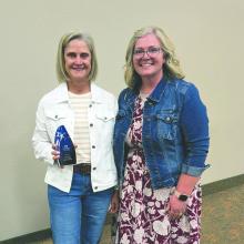 Amy Lilly (left) receives the 2026 Finance Officer of the Year Award from Michelle DeNeui (right), president of the South Dakota Governmental Finance Officers’ Association, during the group’s annual training June 11 in Oacoma, S.D. Submitted photo
