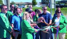 (Above) Siouxland Chamber of Commerce Ambassadors joined North Sioux City and Dakota Dunes CID officials for a ribbon cutting marking the completion of the Sioux Point Pedestrian/Bike Path connection at North Shay Road and Sioux Point Road. (Left) A new welcome sign stands along Sioux Point Road near Saint Teresa of Calcutta Catholic Church in Dakota Dunes, close to the location of the trail connection. Photos by Kelly Riibe • times2reporter@gmail.com