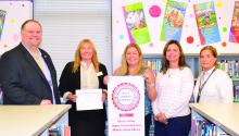 Dakota Valley's library staff was presented with a banner, on September 24, 2026, for earning the School Achievement Through Libraries (SATL) Award. From left: George Seamon, Scottie Bruch, Erin Nilges, Jamie Bruns and Gail Konopasek. Photo by Kelly Riibe • times2reporter@gmail.com