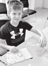 Will Konopasek puts together a 3-D puzzles of an octopus. Photos by Kelly Riibe