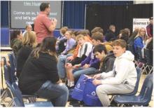 Volunteers of Beacon Church, on the left, assist EPJ students, on the right, to find their correct shoe size and make sure they fit. Students pictured, from front to back, are, Connor Sayler, Ben Prouty, Luke Schmitz, Anthony Tatro, Jackson Neal and Molly Geary. Photo by Beth Sherard-Hutcheson • times1reporter@gmail.com