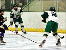 Defenseman Grant Harder passes the puck to Forward Blaze Bauer during Sunday’s matchup with the Lincoln Jr. Stars. Photo courtesy of Brooke Harder