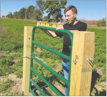 Keenan is seen here leveling a gate for his archery range project for the Tri-State Youth Association. Submitted photo