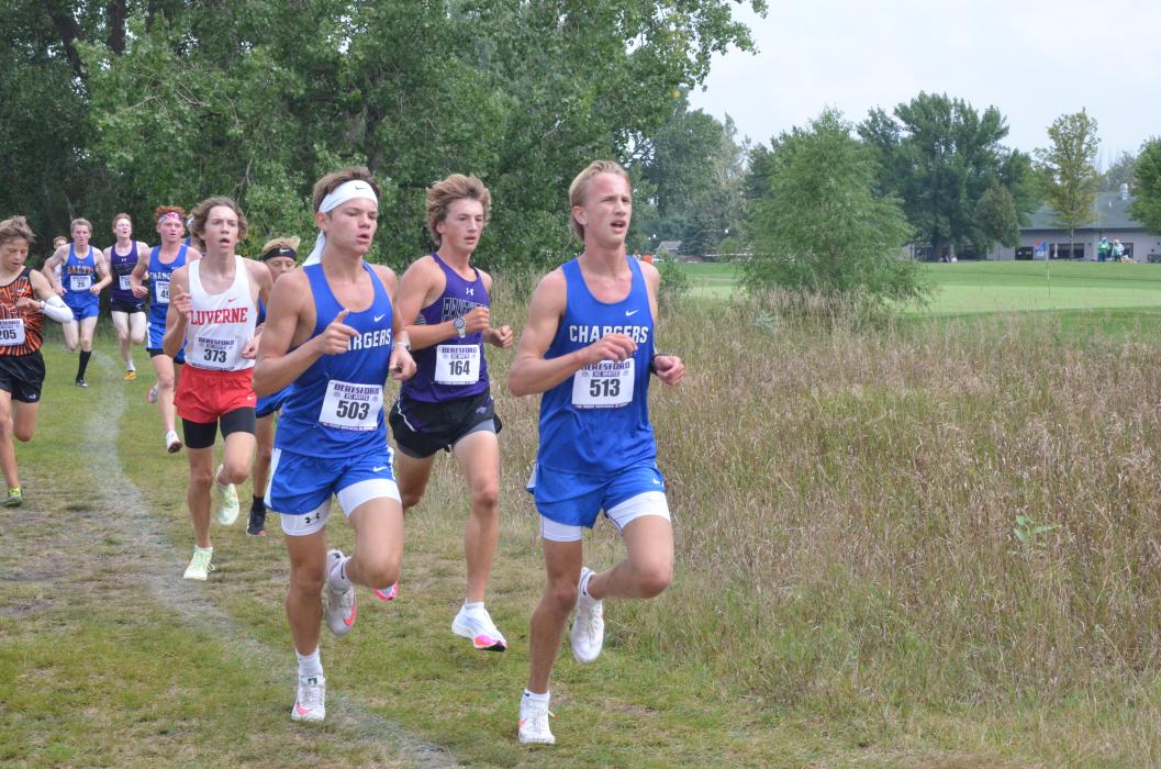 Jack Brown, behind two Sioux Falls Christian Charger runners, broke the school meet record on the Beresford course Aug. 26. Blake Schmiedt held the record at 17:21 and Brown broke it with a time of 17:09. Photo by Kelly Riibe