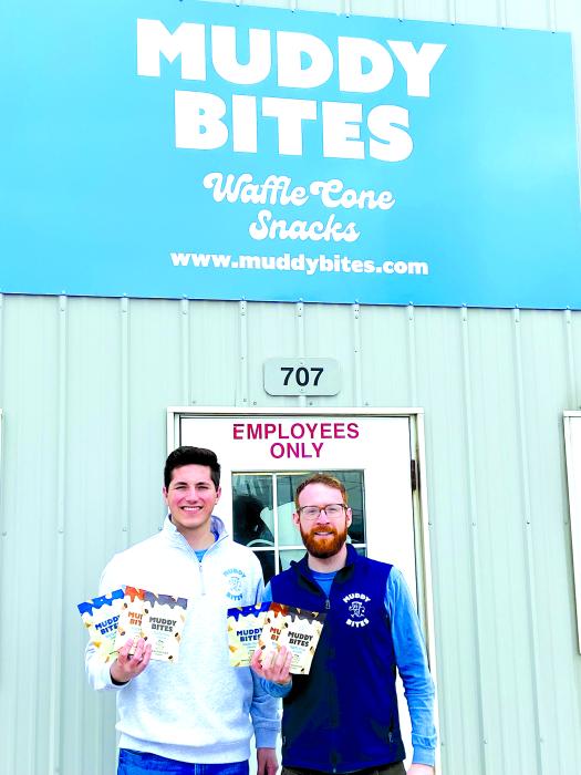 Jarod Steffes and Tyler DeVos stand in front of the Muddy Bites warehouse in North Sioux City. In their hands they have the three flavors of Muddy Bites available in over 5,200 locations across the United States.		                  Submitted photos