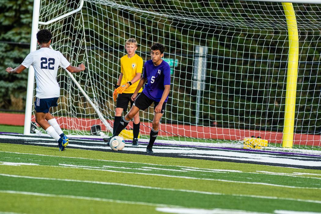 Ethan Christensen blocks the ball before it can get to the net and goalkeeper Reid Herbold. Herbold blocked many shots on the goal during the Freeman Academy game Aug. 27. Photo by Peterman Sports Photography • photoman@iw.net