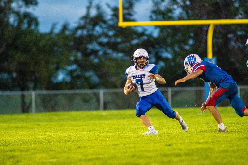 Hunter Geary completed a pass for 13 yards against Parker. He was a huge asset to the Huskies during their second game against Baltic Aug. 26. Photo by Peterman Sports Photography • photoman@iw.net