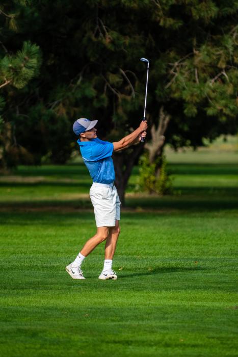 Evan Hailey, a senior, watches his ball go down the fareway at the Husky Invite Sept. 15. Photo by Peterman Sports Photography • photoman@iw.net