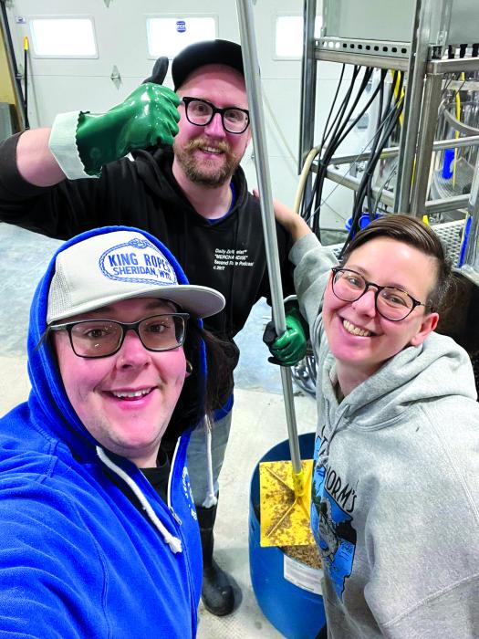 Anthony Roark, Andy McIntosh and Nicki Werner prepare another batch for brewing.  Submitted photo