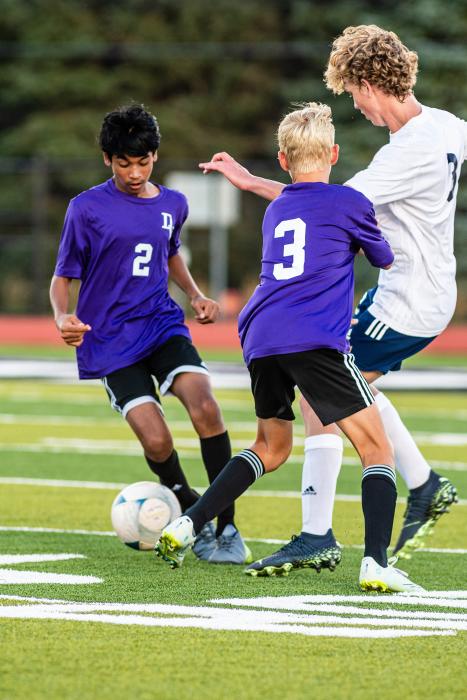 Patil Kshitij makes an offensive maneuver around a Tea Area defender while Jamison Gould sets a screen. Kshitij was able to take two shots at the net against Freeman Academy Aug. 27. Photo by Peterman Sports Photography • photoman@iw.net