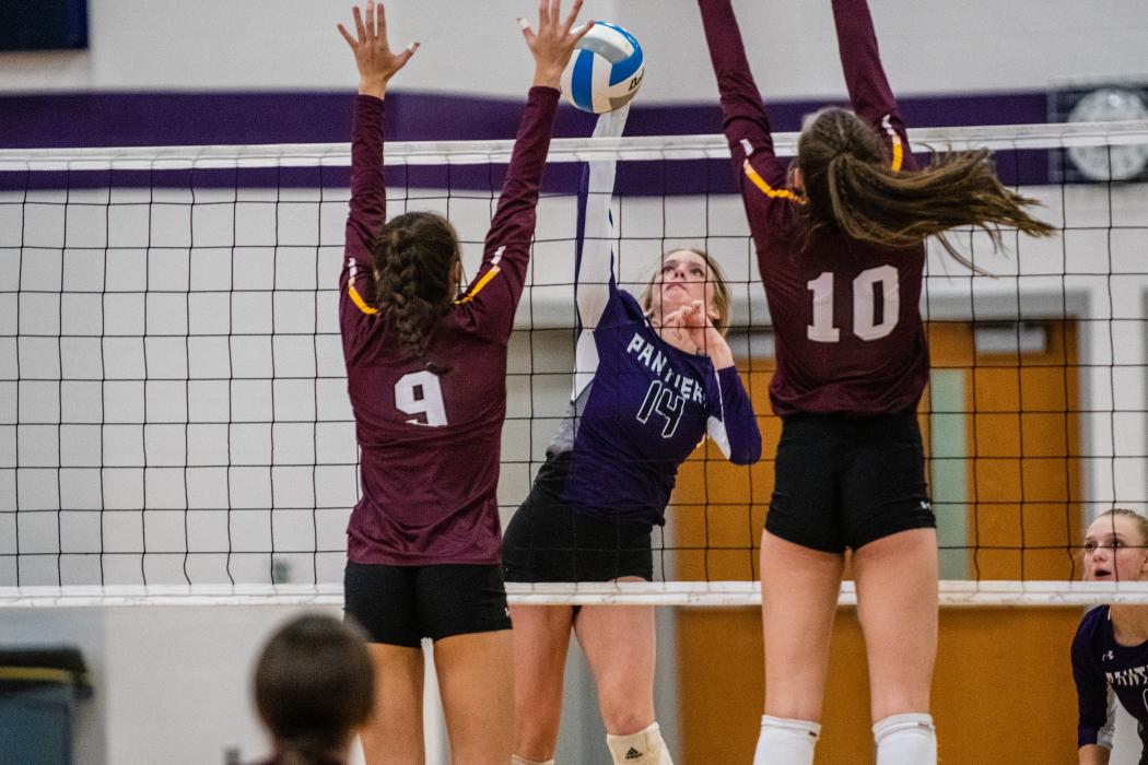Addi Kleis splits the block against Madison and gets the kill. Photo by Peterman Sports Photography stevepeterman5@gmail.com