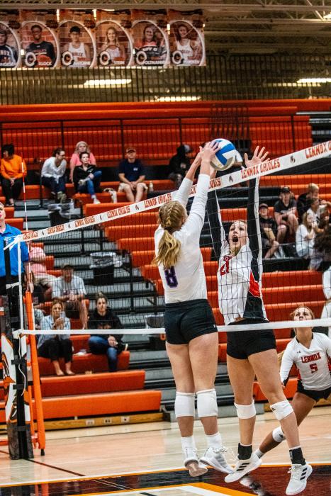 Logan Miller pushes the ball between a block. She had 36 assists during the game against Lennox Oct. 11. Photo by Peterman Sports Photography stevepeterman5@gmail.com