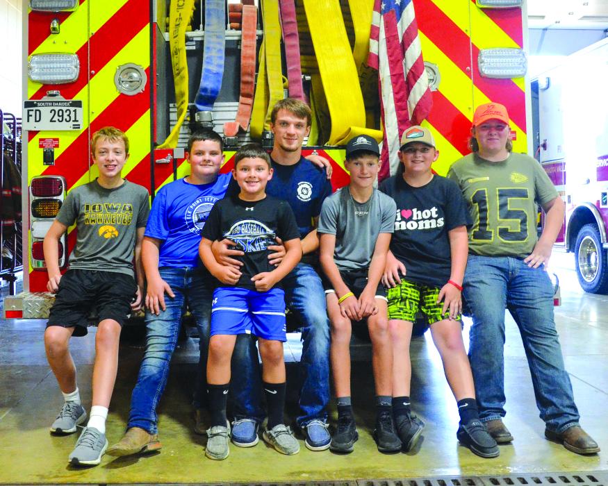 Kadon Streeter (of Sioux City), Thomas Trudeau (of Elk Point), on lap JT Trudeau (of Elk Point), Christian Meuller (fire fighter in training from Jefferson), Mason White (of Elk Point), Tucker Trudeau (of Elk Point) and Jasper Trudeau (of Elk Point) sit on the back of one of North Sioux City’s firetrucks at the department’s open house Oct. 2. The fire department holds the open house as a way to kick off fire prevention week to be recognized Oct. 9-15.  More photos to run next week.  Photo b