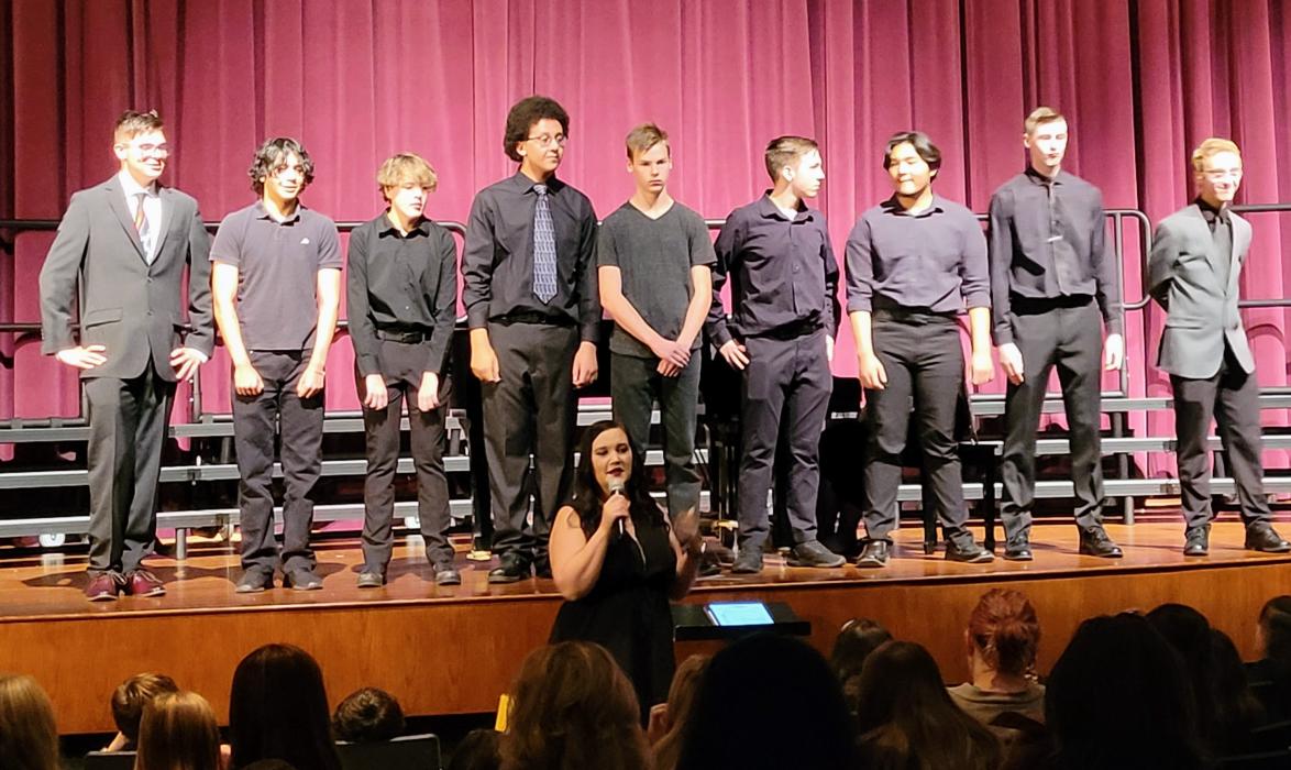 DV’s 7th-12th Grade Bass Clef Ensemble were, from left, Peyton Machan, Ethan Romero, Logan Reyes, Devon Williams, James Pringle, Tavone Keomanyvong, Preston Carlson and Cody Morse. Choir Director Kari Wilmes is holding the microphone in front of the group.  Photo by Kelly Riibe • times2reporter@gmail.com