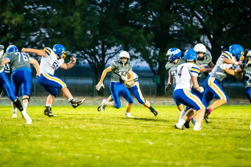 Jakob Scarmon runs up the gut to get the Huskies down the field. Photo by Peterman Sports Photography • stevepeterman5@gmail.com