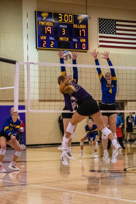 Sophie Tuttle splits the block to land the kill.  Photo by Peterman Sports Photography stevepeterman5@gmail.com