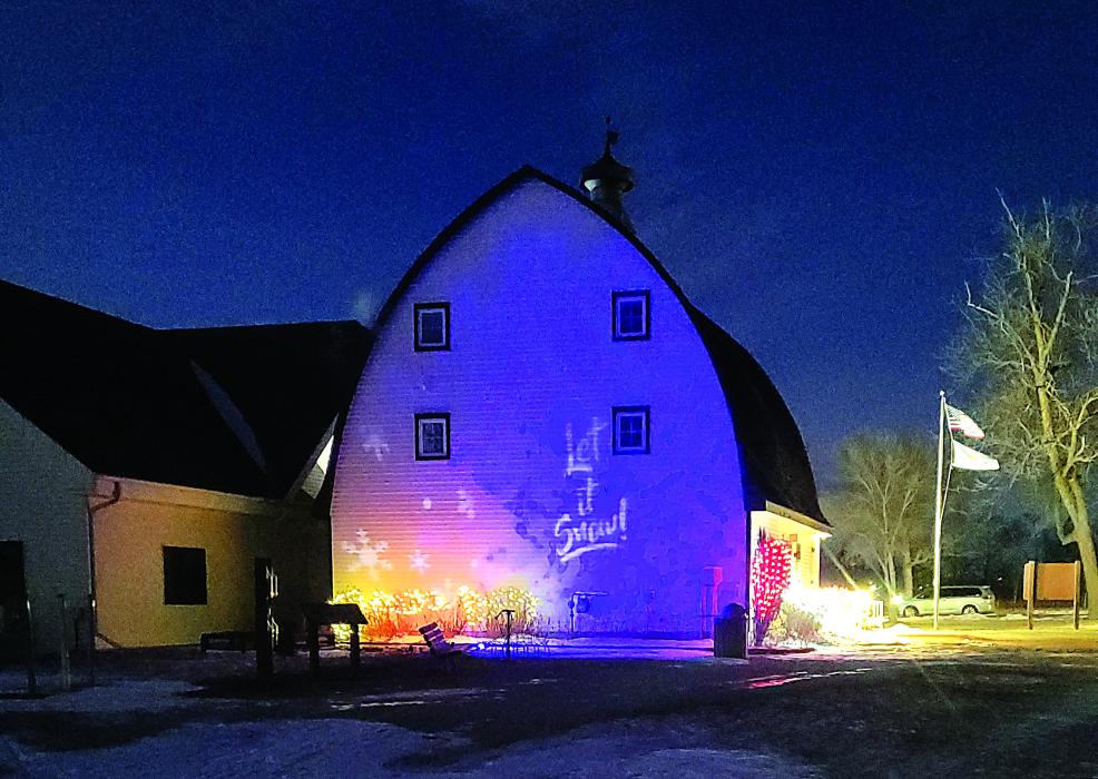 A projected holiday message was on display along the backside of the Visitor Center at Adams Homestead and Nature Preserve. Photo by Kelly Riibe • times2reporter@gmail.com