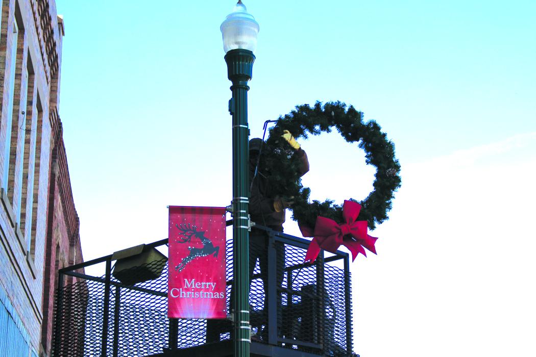 A telltale sign that Christmas is around the corner is the decorating of Main Street Elk Point’s light poles. City workers added the festive adornments Monday, Nov. 28 while the temperatures held before a predicted snowstorm hit the area. Photo by Beth Sherard-Hutcheson times1reporter@gmail.com