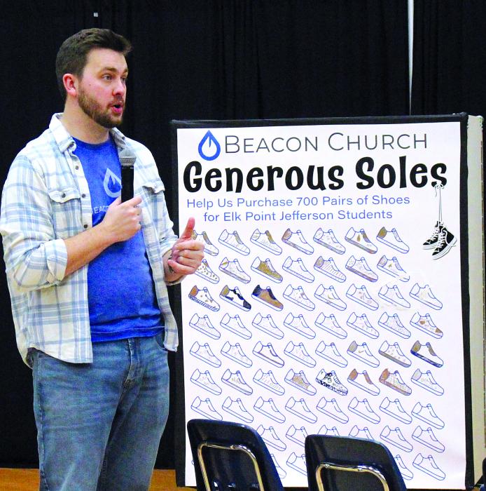 Ben Miller, pastor of Beacon Church, informs the volunteers of the schedule of students that will be coming next into the gym. Photo by Beth Sherard-Hutcheson • times1reporter@gmail.com