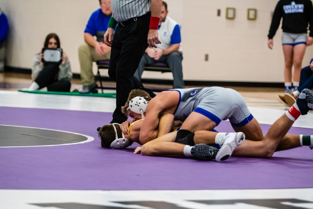 Lucas Hueser (152 lbs) works to turn his opponent Chandler Carda of West Central.