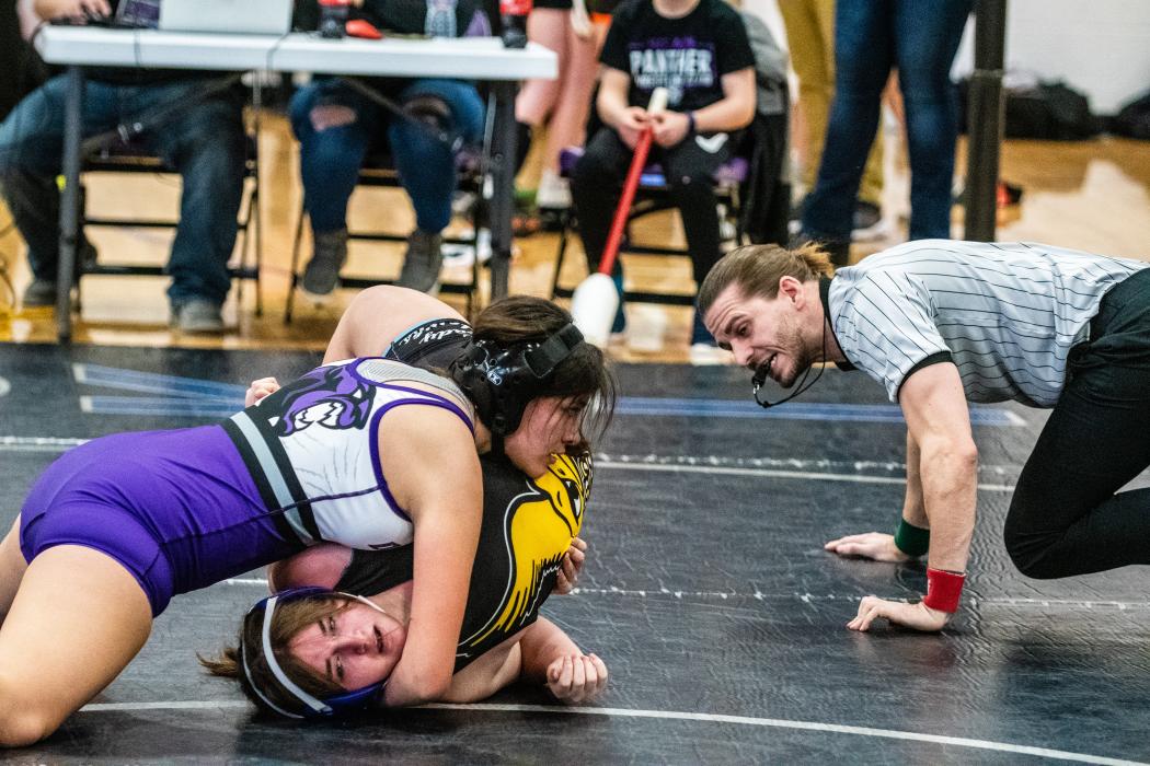 Gracie Delgado watches the ref for his signal that she got the pin over Kenzie King of Canton in the DAK-12 Conference Meet. Photo by Peterman Sports Photography • stevepeterman5@gmail.com